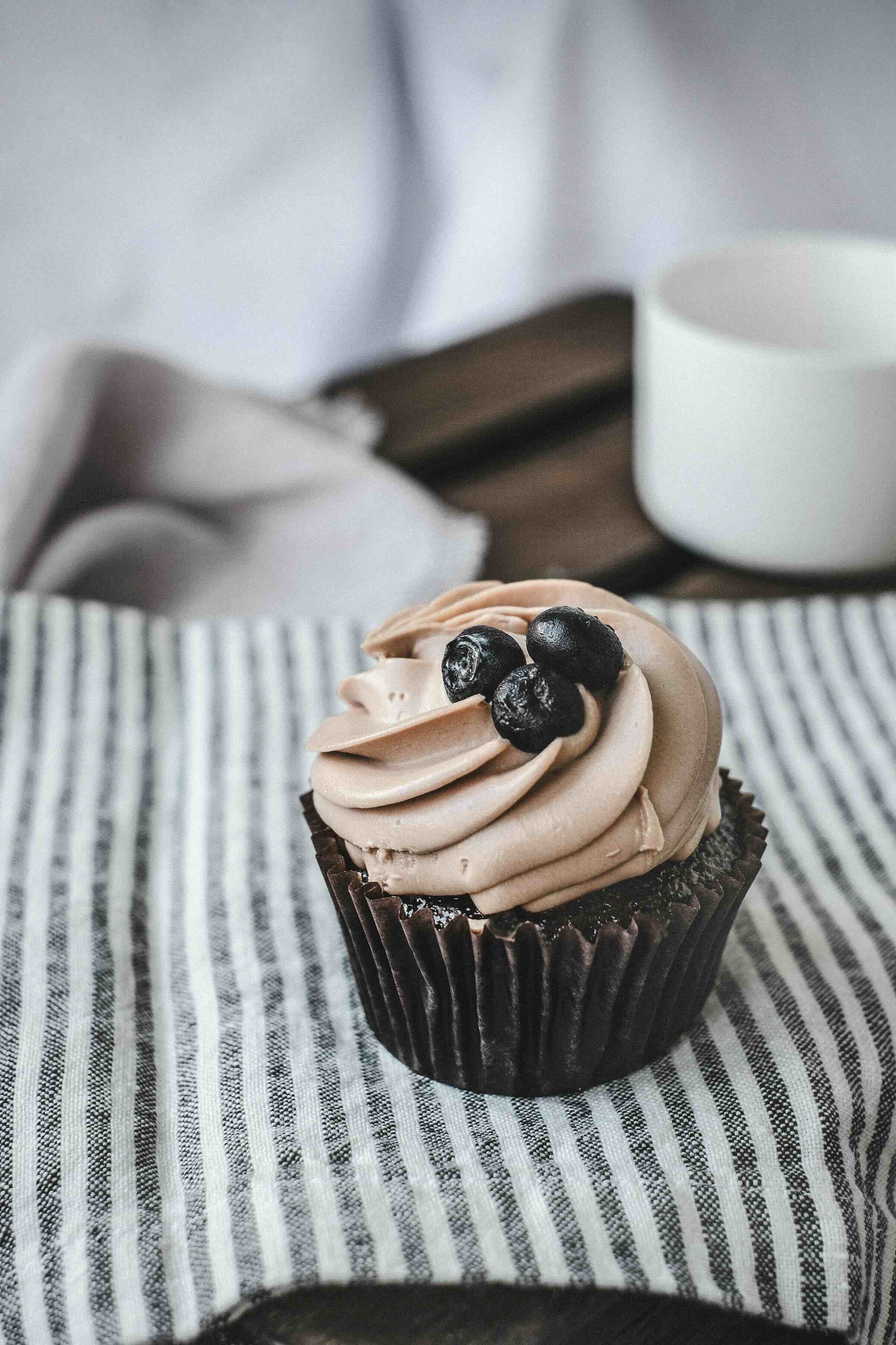 Chocolate cupcake with mocha frosting and fresh blueberries